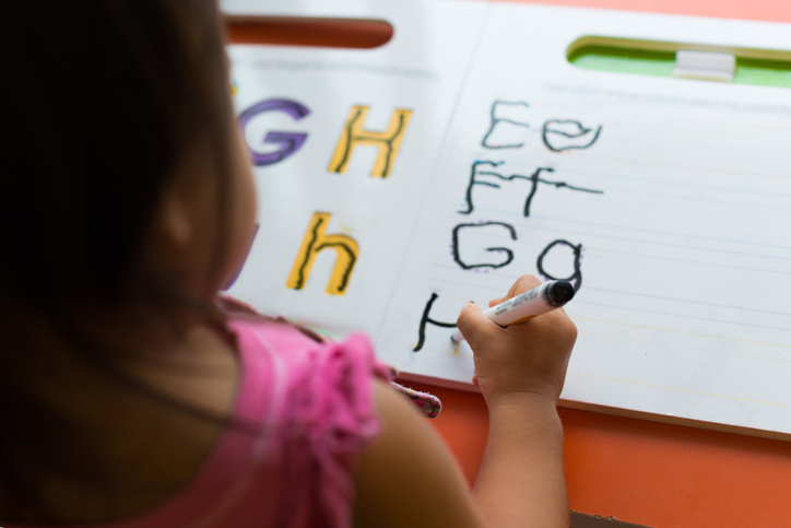 Child practising handwriting - Investing in establishing evidence