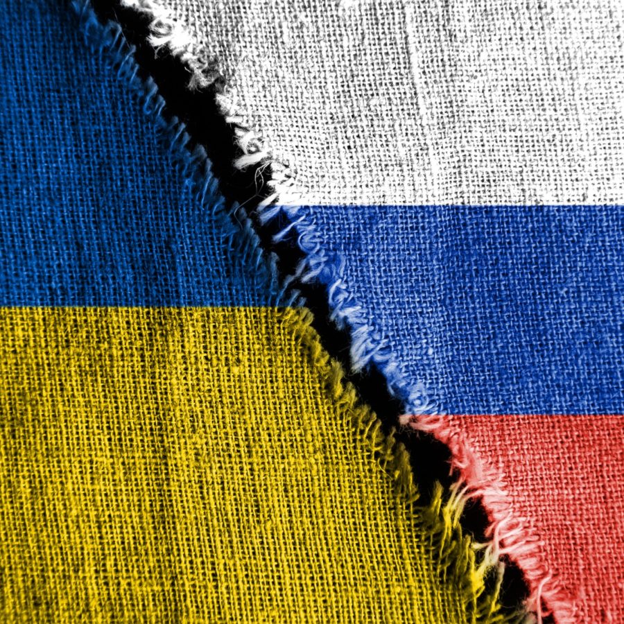 The economic Cost of Ukraine Russia torn flags