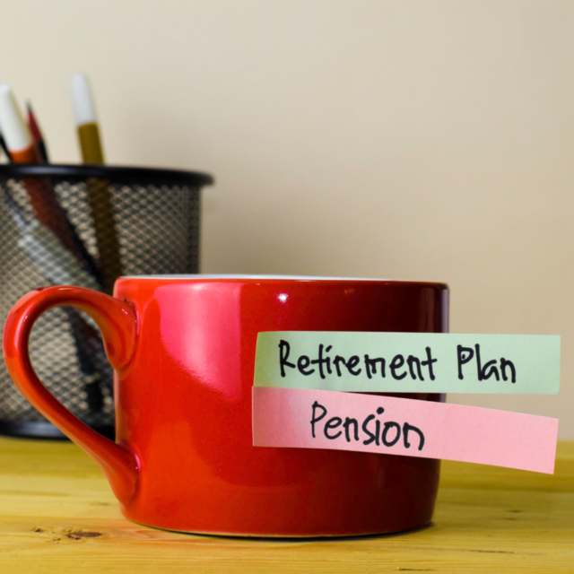Red mug with sticky notes with retirement plan and pension written on them.