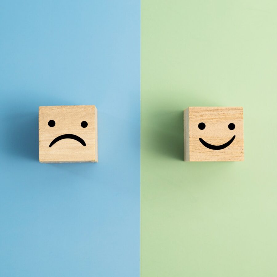 Happy And Angry Faces On Wooden Blocks
