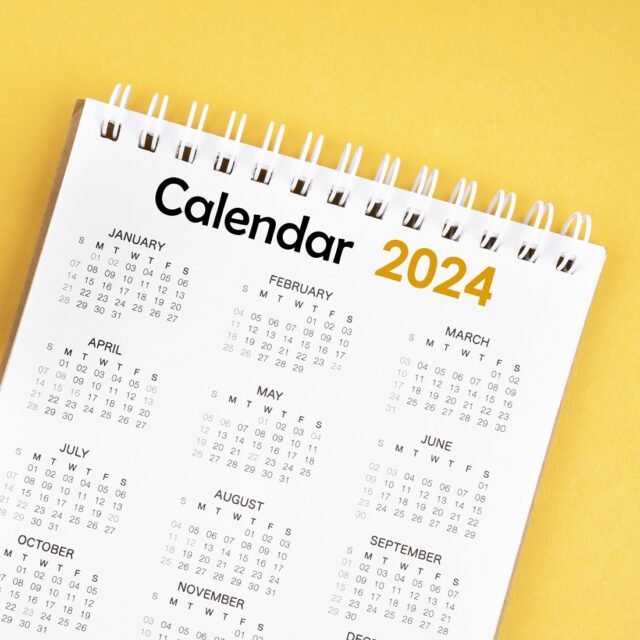 12 months desk calendar 2024 on yellow background.