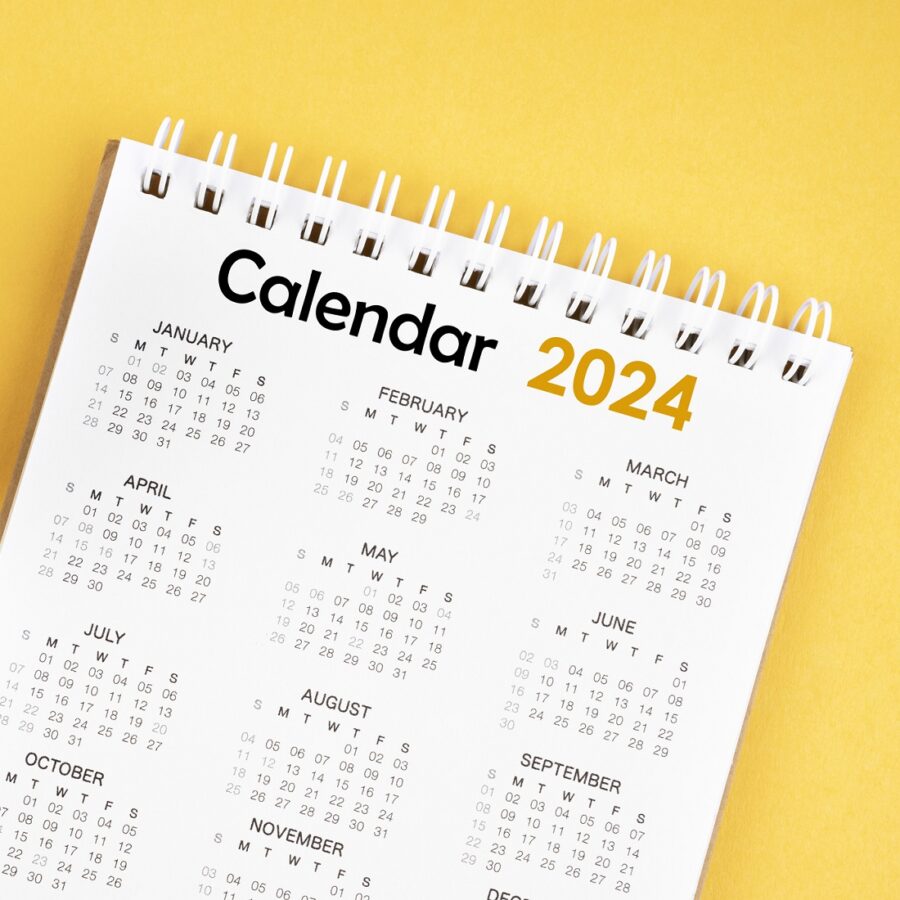 12 months desk calendar 2024 on yellow background.